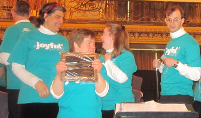 Jodi accepts Joyful
Noise's plaque for performing at ACDA's 2011 National Conference Jodi accepts Joyful Noise's plaque for performing at ACDA's 2011 National Conference